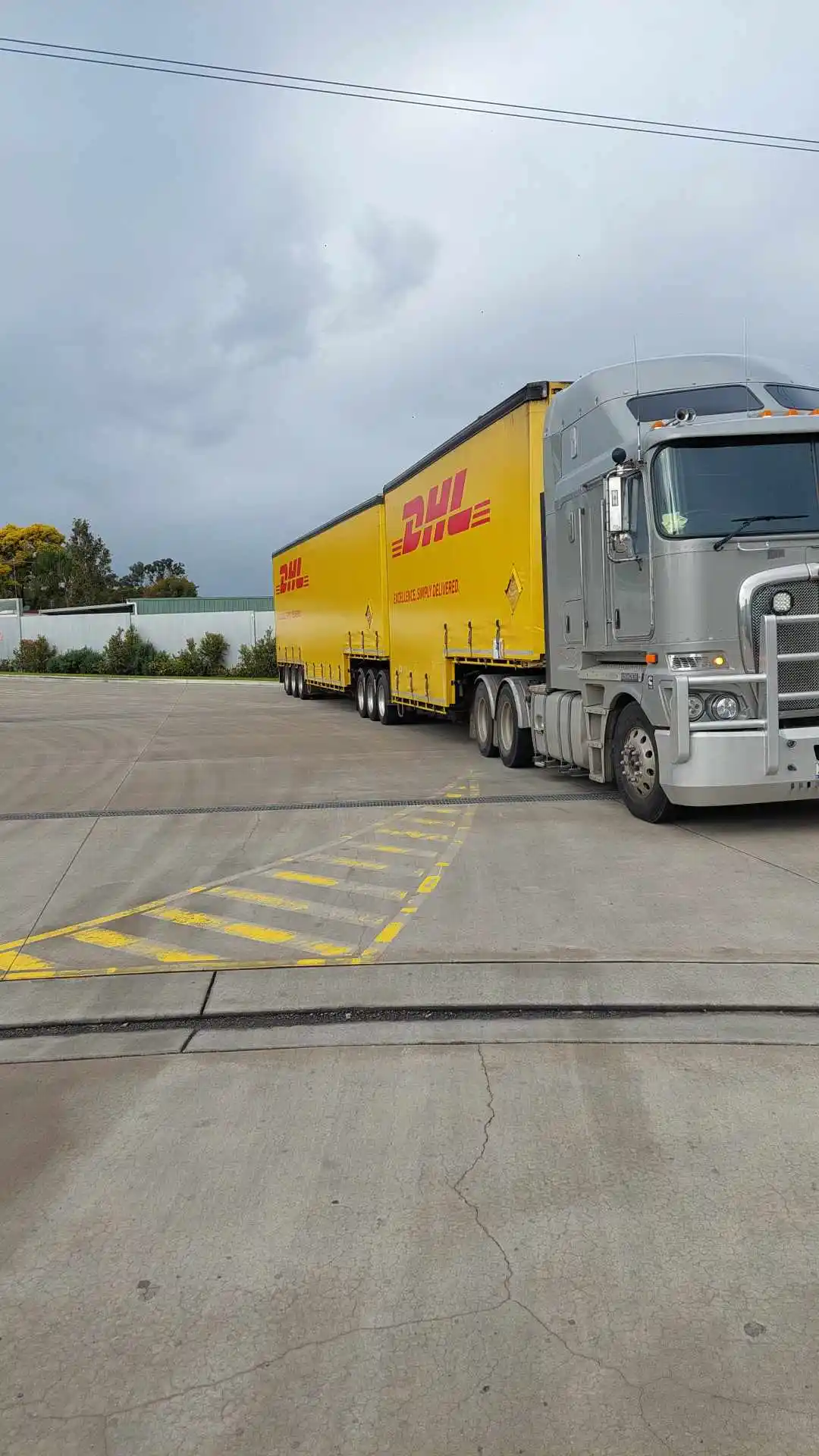 Logmaster Australia Parked Silver and Yellow Truck